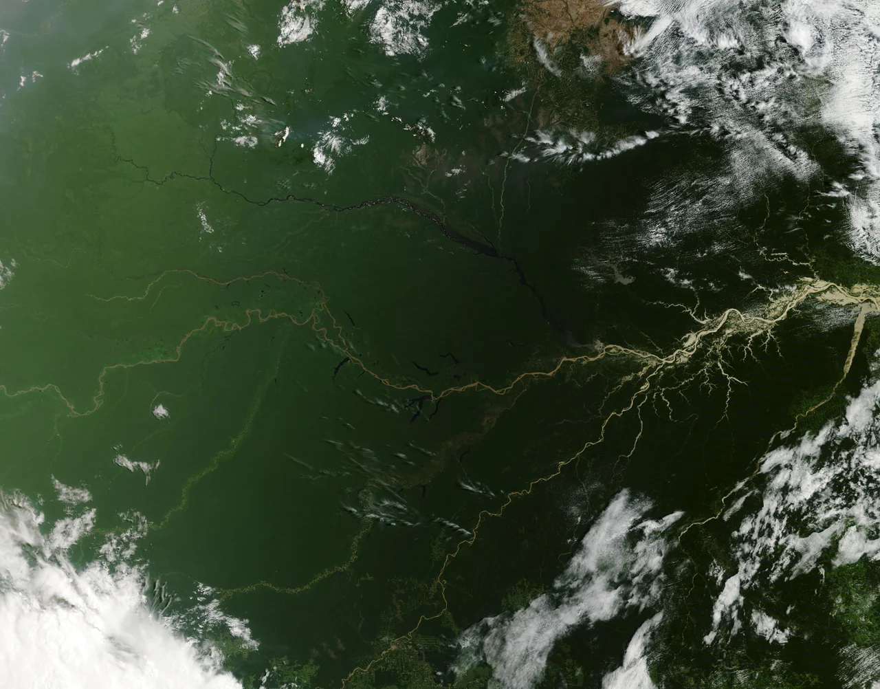 A picturesque line of thunderstorms and numerous circular cloud patterns filled the view as the International Space Station (ISS) Expedition 20 crew members looked out at the limb (blue line on the horizon) of the Earth.
The region shown in the photograph includes an unstable, active atmosphere forming a large area of cumulonimbus clouds in various stages of development. The crew was looking west-south-west from the Amazon Basin, along the Rio Madeira toward Bolivia when the image was taken. The distinctive circular patterns of the clouds in the photograph are likely caused by the ageing of thunderstorms. Such ring structures often form during the final stages of storms development as their centres collapse.
Sun-glint, the mirror-like reflection of sunlight off a water surface directly back to the camera on-board the ISS—is visible on the waters of the Rio Madeira and Lago Acara in the Amazon Basin. Widespread haze over the basin gives the reflected light an orange hue. The Rio Madeira flows northward and joins the Amazon River on its path to the Atlantic Ocean. A large smoke plume near the bottom centre of the image may be one source of the haze.
The image was acquired with a Nikon D2Xs digital camera using an effective 48mm lens (28-70 mm zoom lens), and is provided by the ISS Crew Earth Observations experiment and Image Science & Analysis Laboratory, Johnson Space Centre.