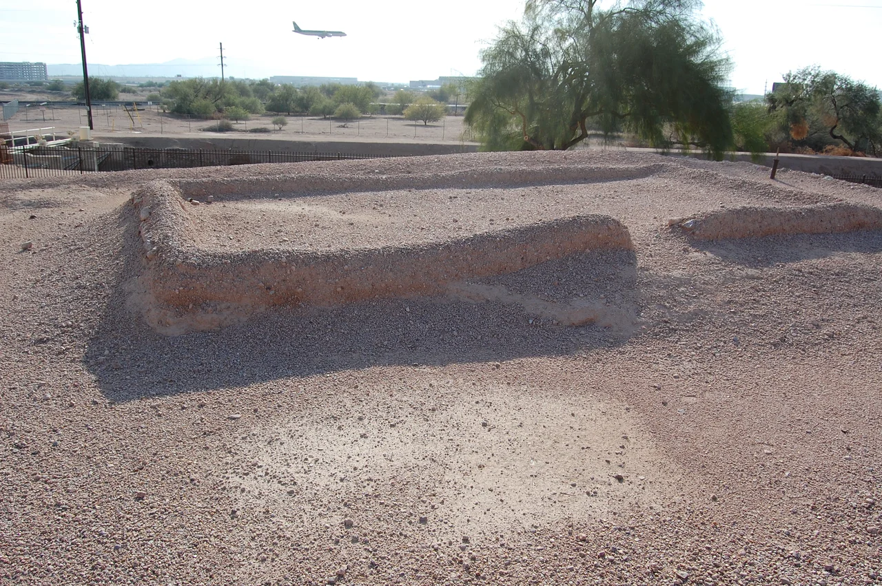 Ruins of a building at Pueblo Grande archaeological site in Phoenix, Arizona. Note the plane landing at Sky Harbor International Airport just behind the dig site.