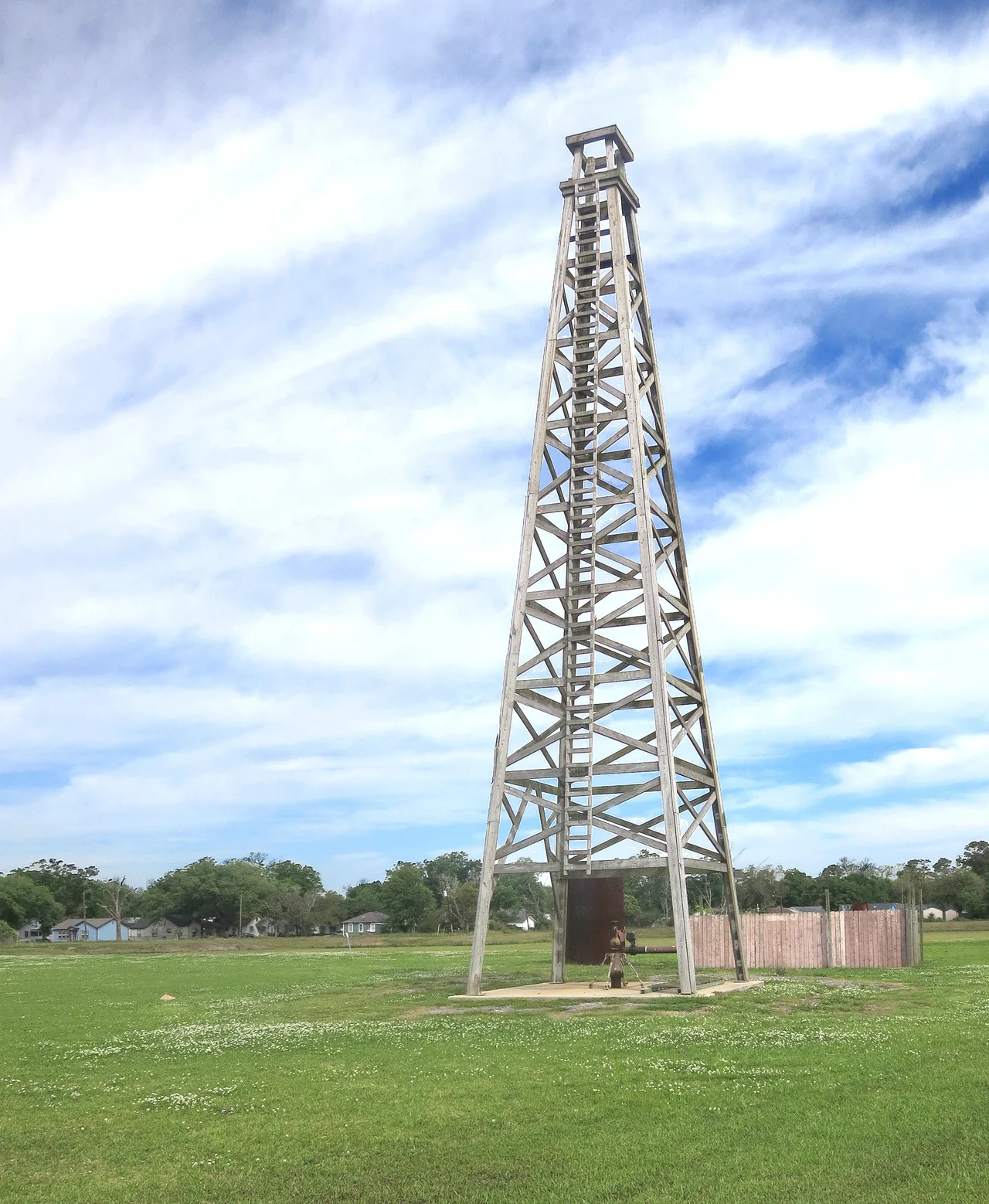 Discovery well of the Spindletop Oil Field changed Texas. It was the first important well on the Gulf Coast. It blew in on Jan. 10, 1901, flowing 100,000 barrels of oil a day from a depth of 1020 feet. The oil production which resulted made Beaumont a city and Texas the major oil refining and exporting center of the world, which it still is today. The Lucas Gusher was drilled by the Hamill Brothers, contractors, under the direct supervision of Captain Anthony F. Lucas for Guffey and Galey of Pittsburgh, on the McFaddin, Weiss and Kyle lease.
This replica of Lucas' famous Spindletop gusher is not located at Spindletop Park, rather it is at Gladys City 1.5 miles away. There is a museum, monument and somehow got the historical marker moved to this place. I don't know the schedule but periodically they shoot a stream of water up and out the top to simulate a gusher.