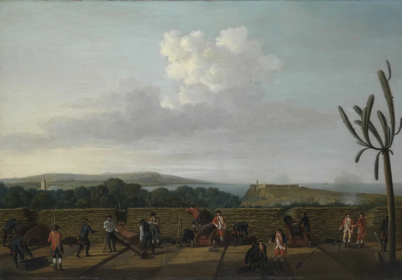 A depiction of an episode from the last major operation of the Seven Years War, 1756-63. It was part of England's offensive against Spain when she entered the war in support of France late in 1761. The British Government's response was immediately to plan large offensive amphibious operations against Spanish overseas possessions, particularly Havana, the capital of the western dominions and Manila, the capital of the eastern. Havana needed large forces for its capture and early in 1762 ships and troops were dispatched under Admiral Sir George Pocock and General the Earl of Albemarle. The force which descended on Cuba consisted of 22 ships of the line, four 50-gun ships, three 40-gunners, a dozen frigates and a dozen sloops and bomb vessels. In addition there were troopships, storeships, and hospital ships. Pocock took this great fleet of about 180 sail through the dangerous Old Bahama Strait, from Jamaica, to take Havana by surprise. Havana, on Cuba's north coast, was guarded by the elevated Morro Castle which commanded both the entrance to its fine harbour, immediately to the west, and the town on the west side of the bay. The castle was built on rock, with massive rock-cut ditches defending it to landward. It was, however, overlooked by the high ground of the Cabana ridge (Los Cavannos) to the south-east. Despite Spanish defence of the ridge, the British managed to take it and set up a battery there from which to bombard the castle at a distance.
This painting shows the inside of the battery, made from a timber platform with a parapet of fascines. The gunners wear blue coats. The Morro Castle can be seen in the distance on the right, with the bell-tower of Havana cathedral on the left. The main harbour lies below, hidden by the trees in the centre.
